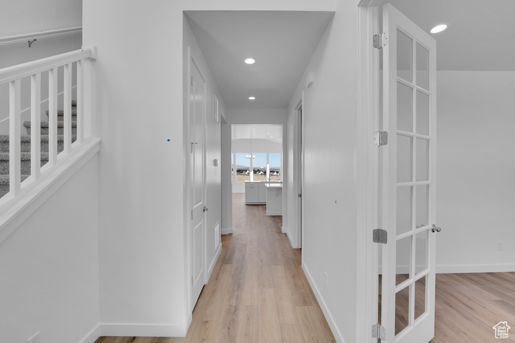 Hallway with light wood-style flooring, recessed lighting, and baseboards