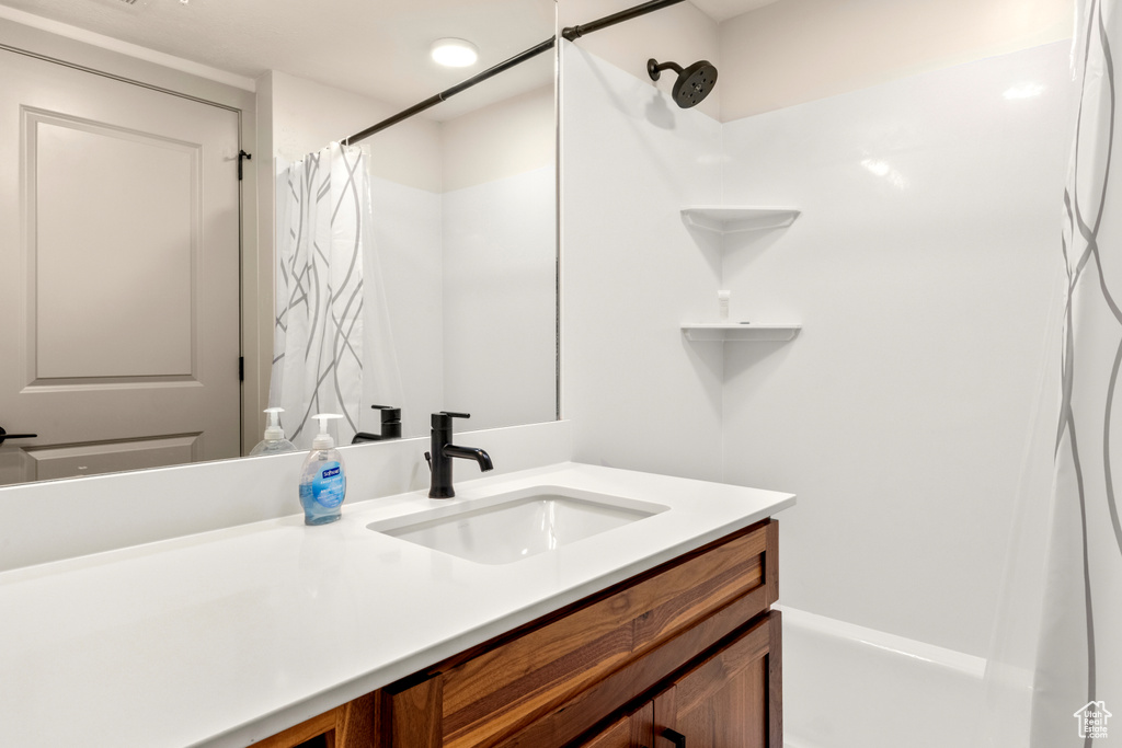 Bathroom featuring vanity and curtained shower