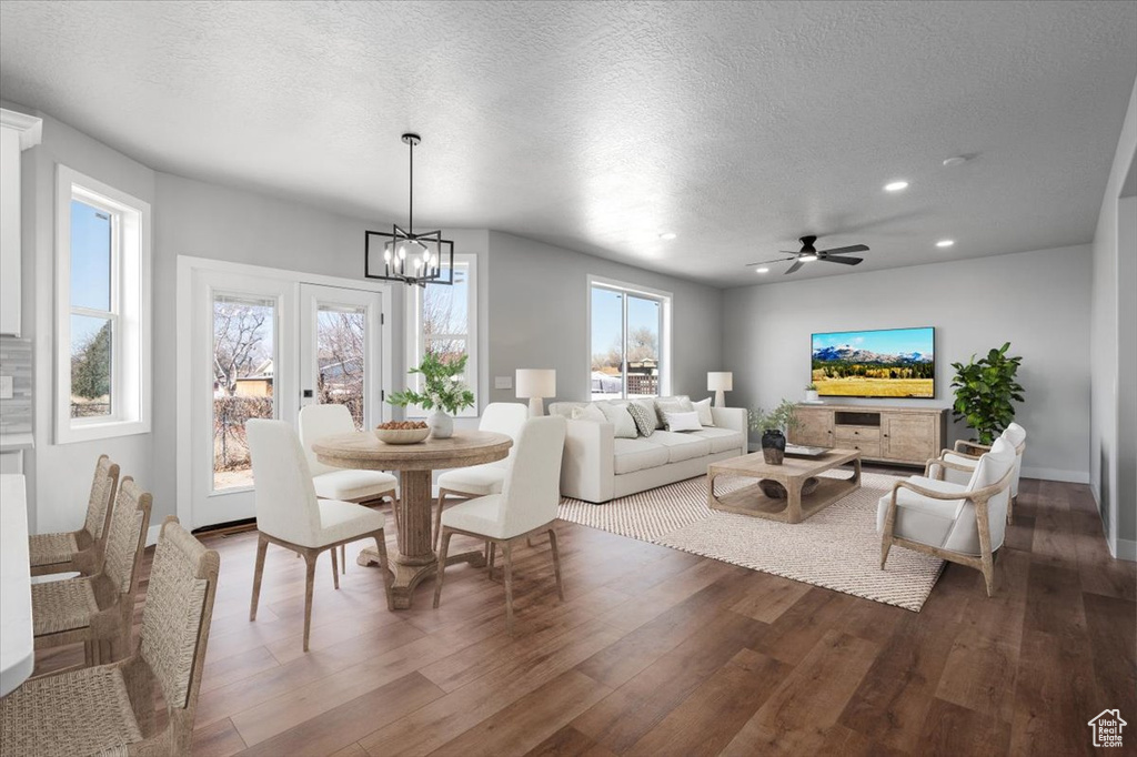 Dining area featuring a chandelier, wood finished floors, a textured ceiling, recessed lighting, and ceiling fan