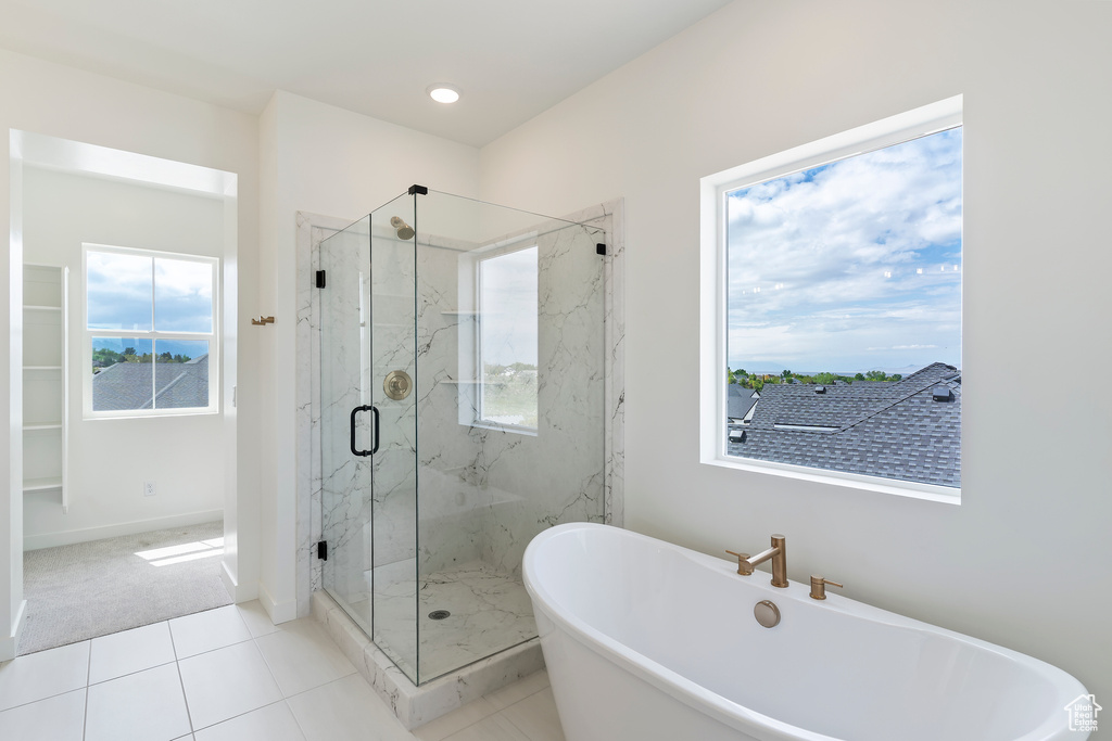Bathroom featuring a soaking tub, a marble finish shower, tile patterned flooring, baseboards, and recessed lighting