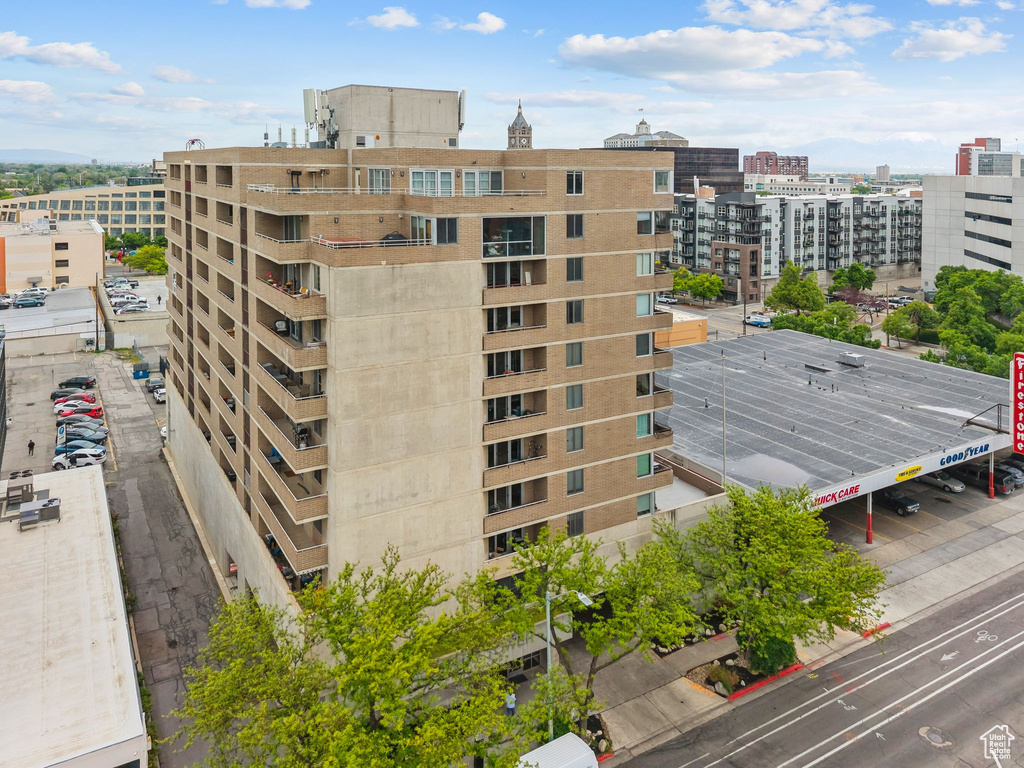 View of property with a city view and uncovered parking