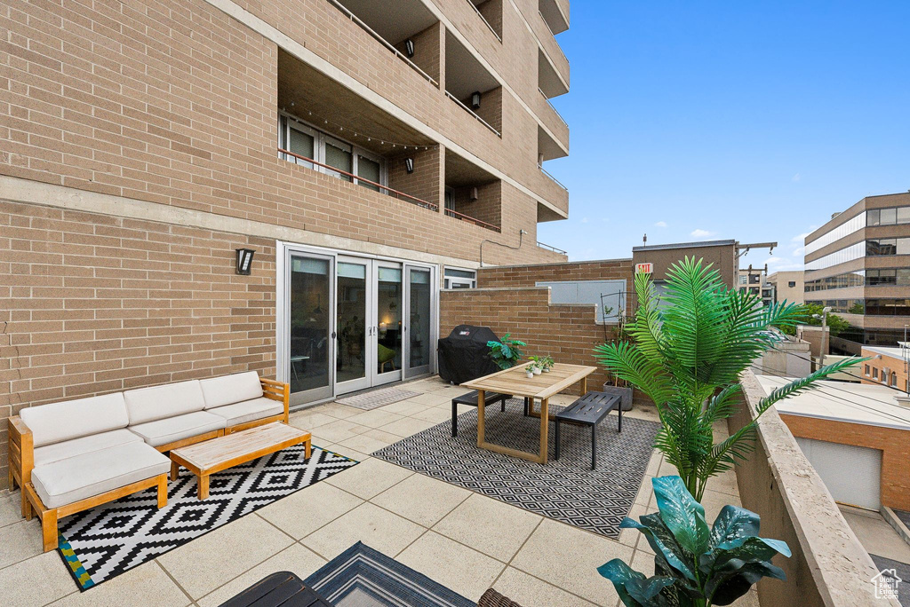 View of patio with french doors and a balcony