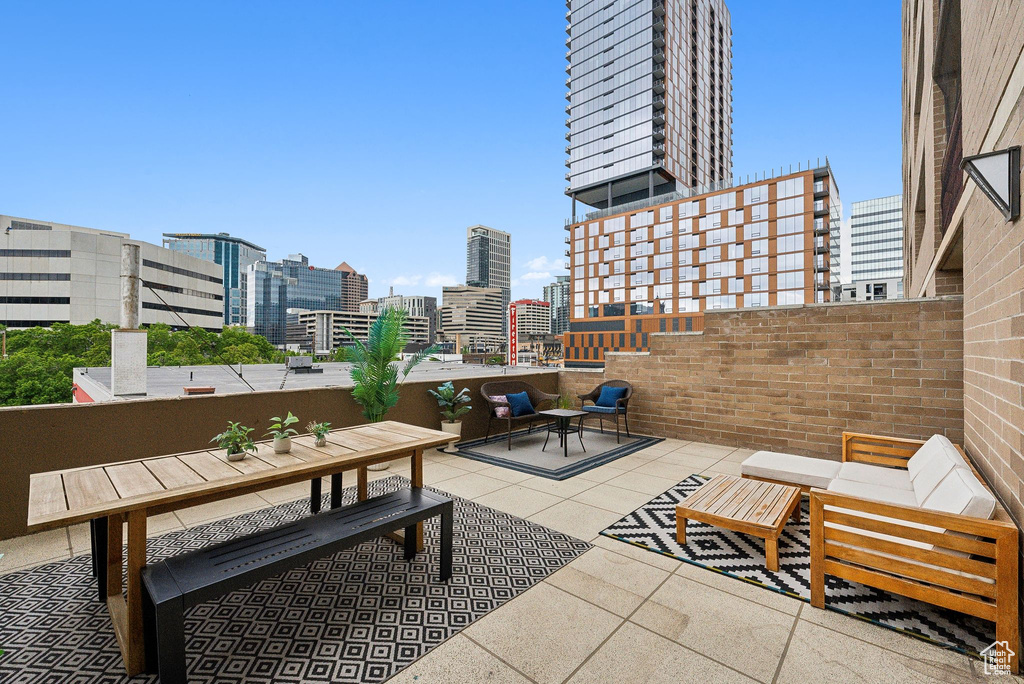 View of patio / terrace featuring a view of city and outdoor dining space