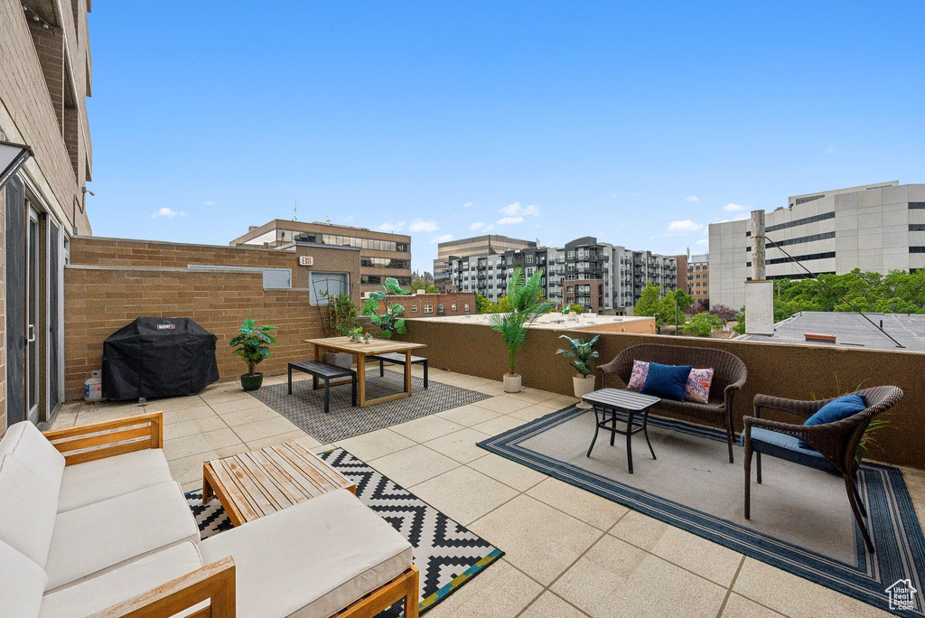 View of patio with an outdoor living space, grilling area, and a view of city