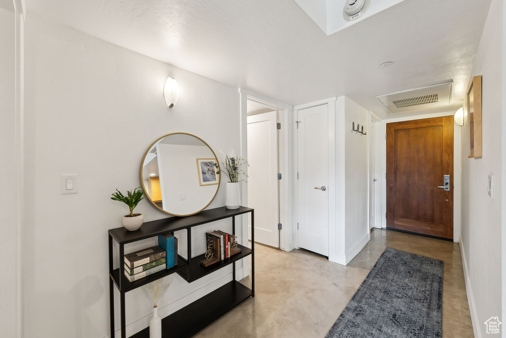 Entrance foyer featuring concrete floors and baseboards