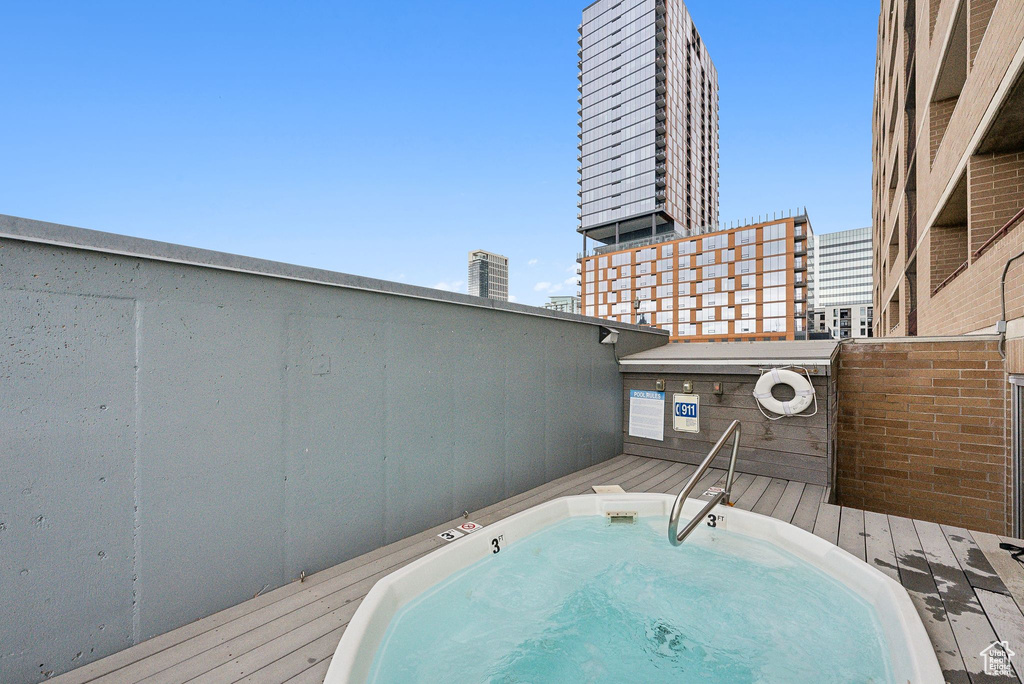View of swimming pool with an outdoor hot tub
