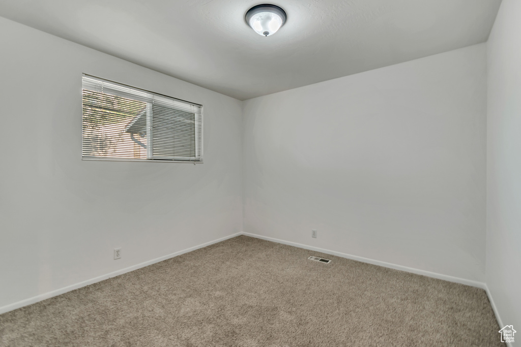 Unfurnished room featuring carpet floors and baseboards