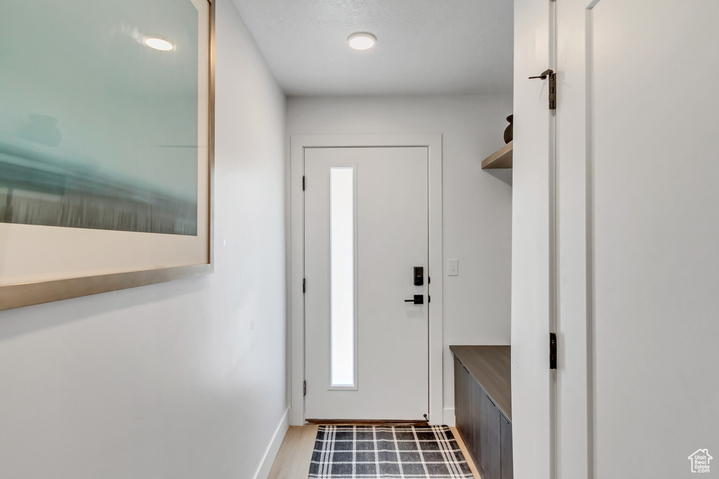 Mudroom with baseboards and wood finished floors