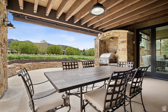 View of patio / terrace featuring area for grilling, a mountain view, and outdoor dining area