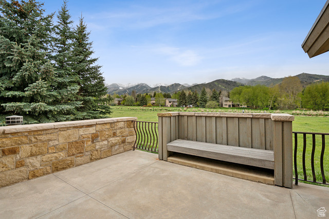View of patio / terrace featuring a mountain view and a view of rural / pastoral area