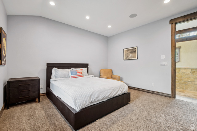 Carpeted bedroom with recessed lighting, lofted ceiling, and baseboards