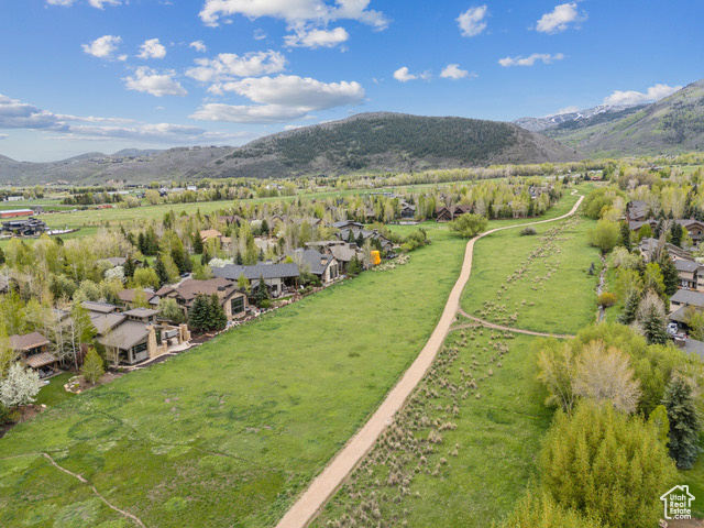 Aerial view of sparsely populated area featuring a mountain backdrop and nearby suburban area