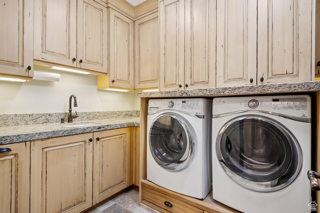 Laundry room with cabinet space and washer and clothes dryer