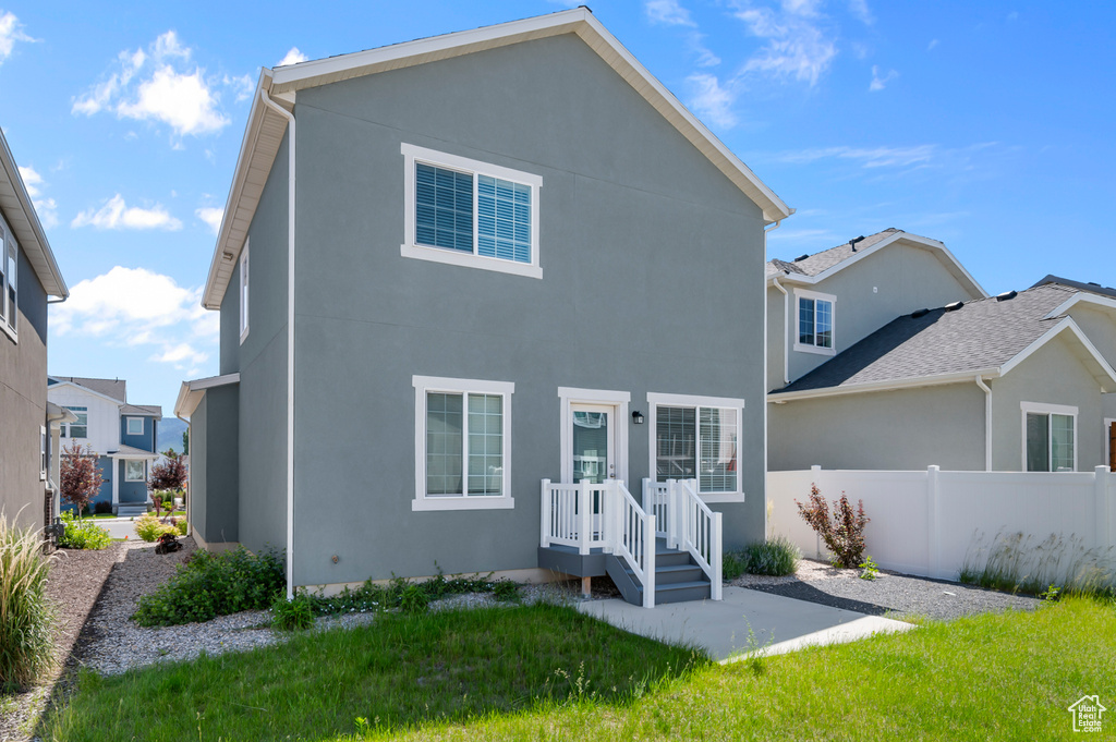 Back of house with stucco siding and a patio area