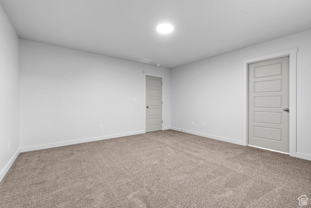 Carpeted spare room with baseboards
