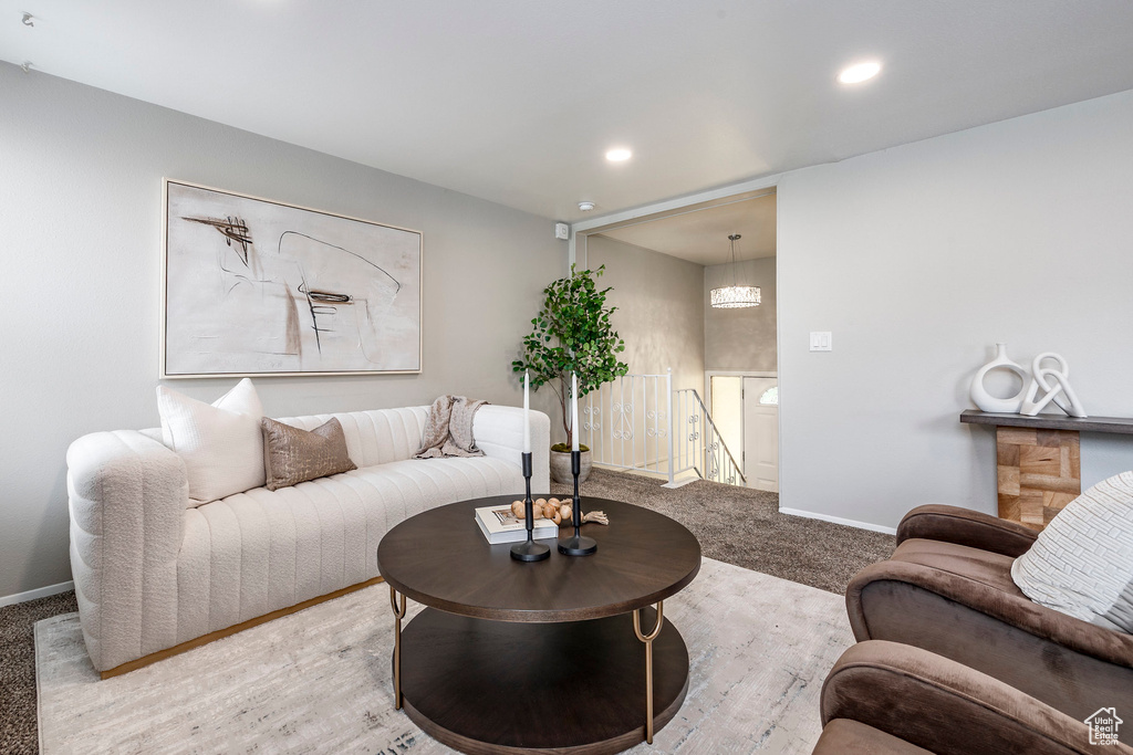 Living room with baseboards, recessed lighting, and carpet flooring