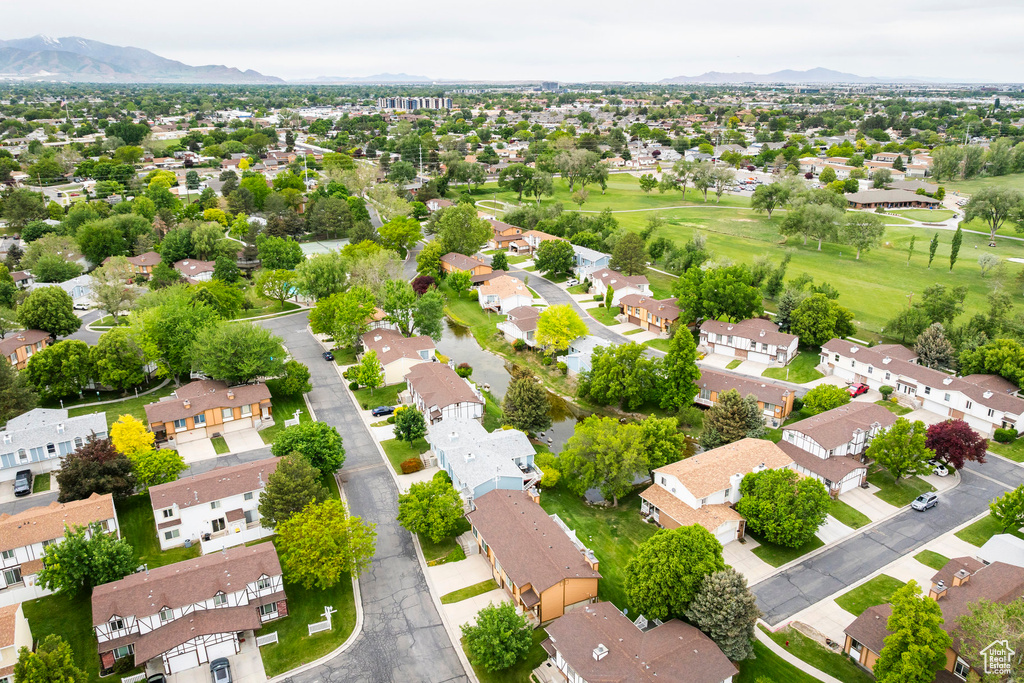 Aerial view of residential area featuring mountains and a golf club