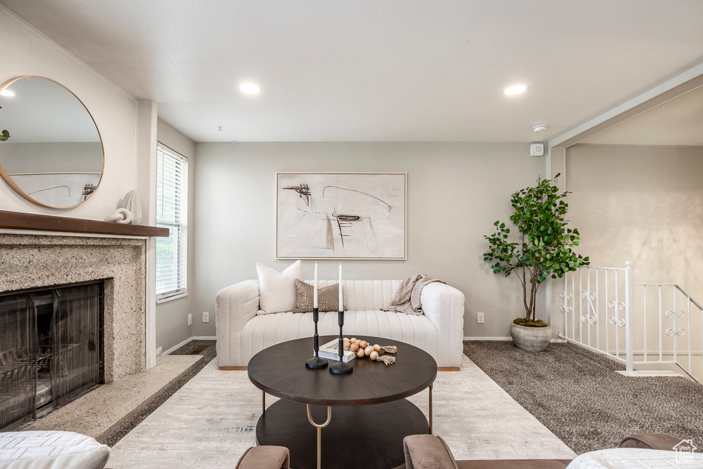 Living room with baseboards, a fireplace, and recessed lighting