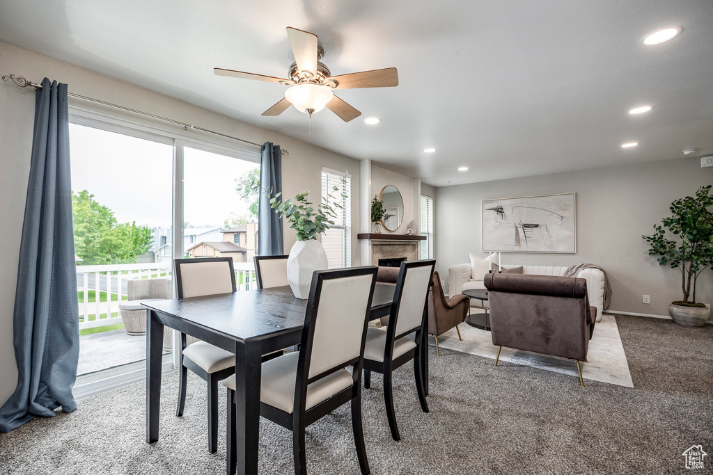 Dining space featuring recessed lighting, a ceiling fan, carpet floors, a fireplace, and baseboards