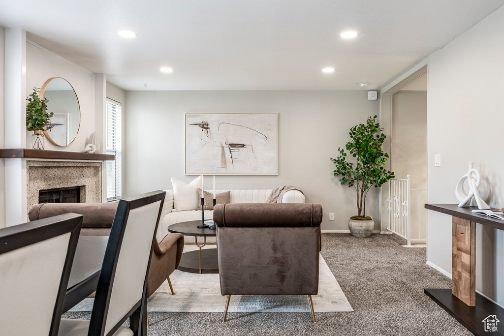 Living room featuring a fireplace, recessed lighting, baseboards, and carpet floors
