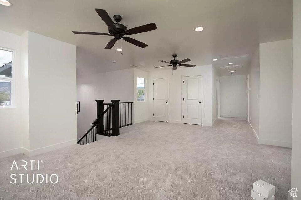 Empty room with carpet flooring, baseboards, recessed lighting, and a ceiling fan