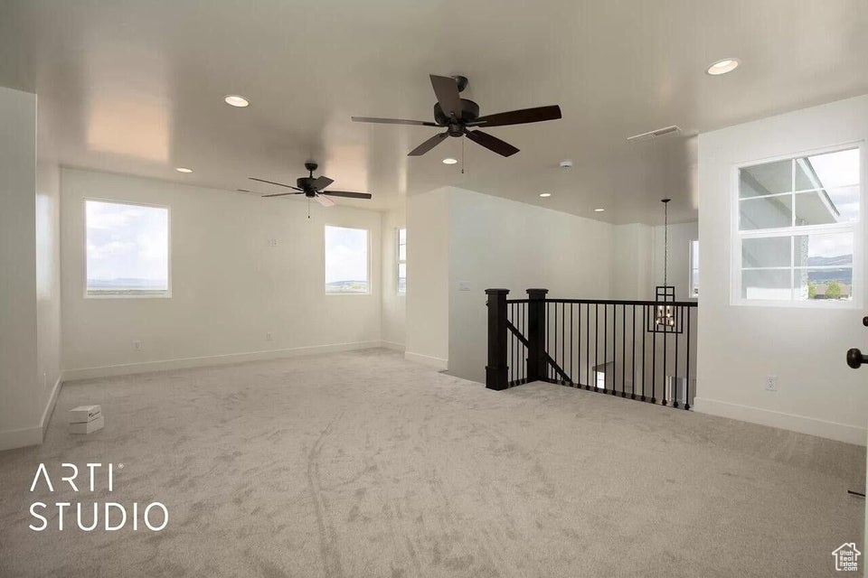 Spare room with carpet, recessed lighting, baseboards, and a ceiling fan