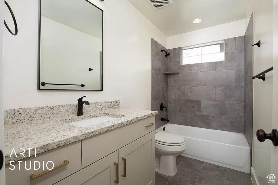 Full bathroom with toilet, shower / tub combination, vanity, and tile patterned floors