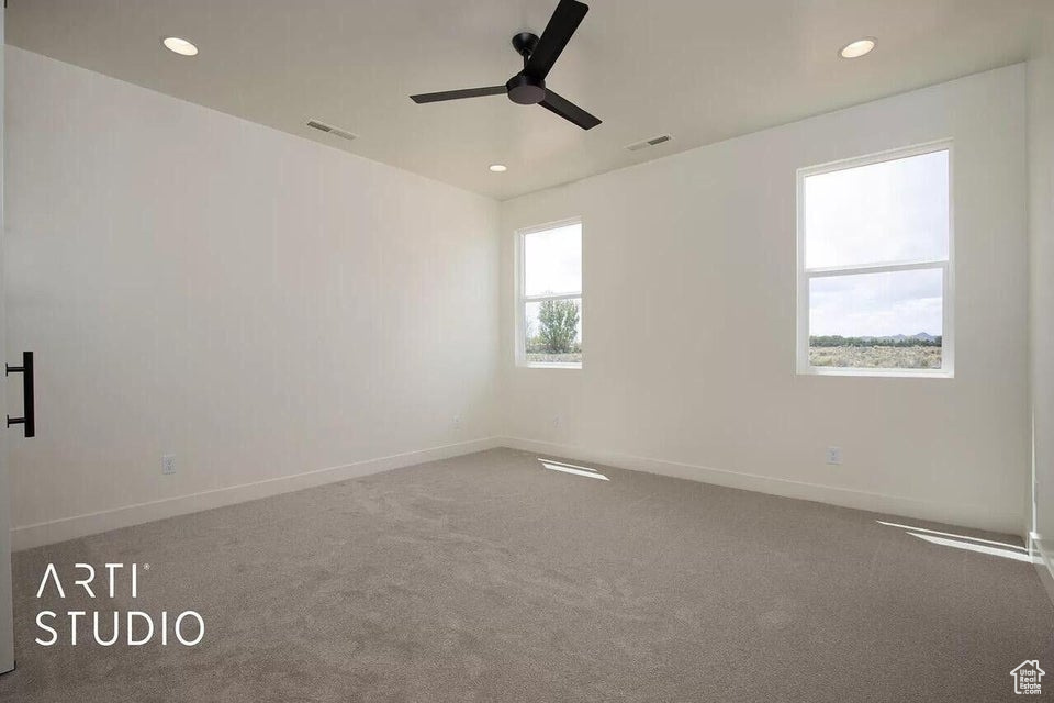Empty room with a ceiling fan, recessed lighting, baseboards, and carpet floors