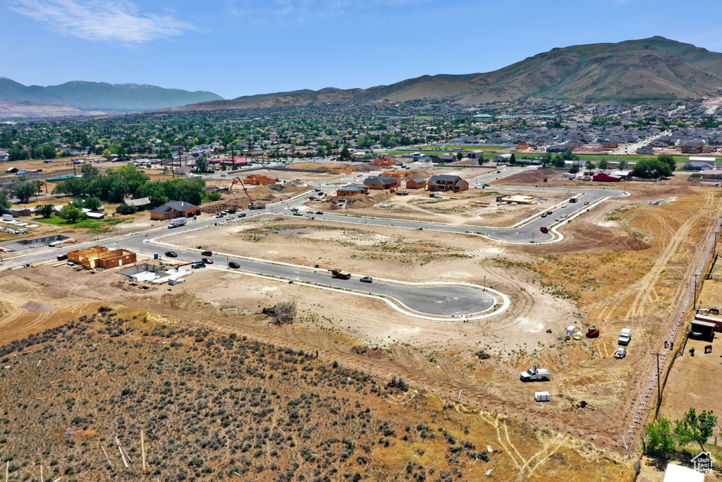Aerial view of property's location featuring a mountainous background