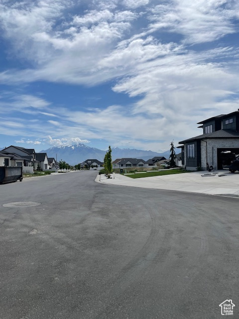 View of asphalt street featuring a residential view and a mountain view