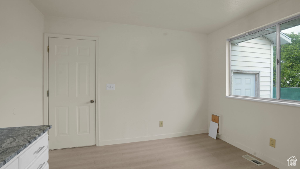 Unfurnished room featuring light wood-style flooring and baseboards