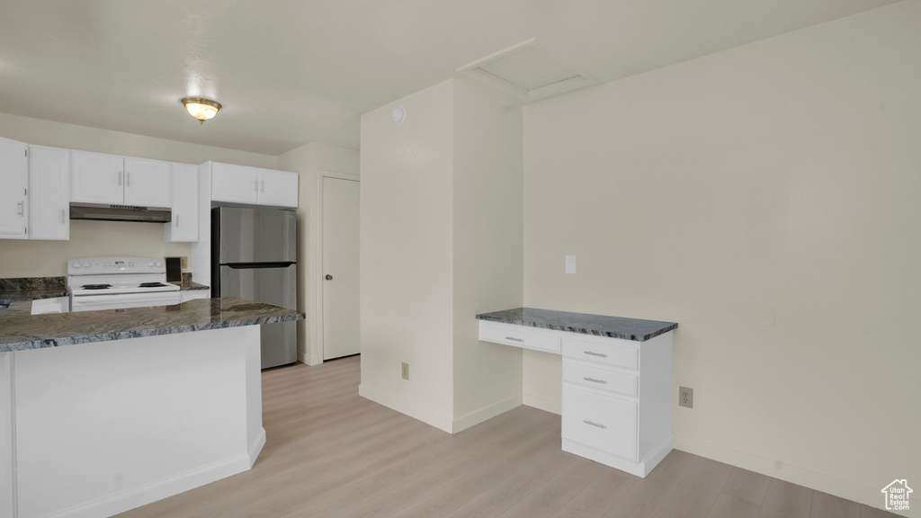 Kitchen with freestanding refrigerator, white range with electric stovetop, light wood finished floors, baseboards, and under cabinet range hood