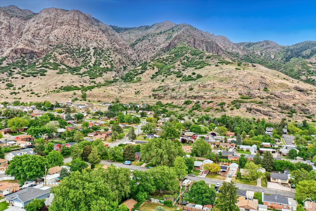 Aerial overview of property's location featuring a mountainous background and nearby suburban area