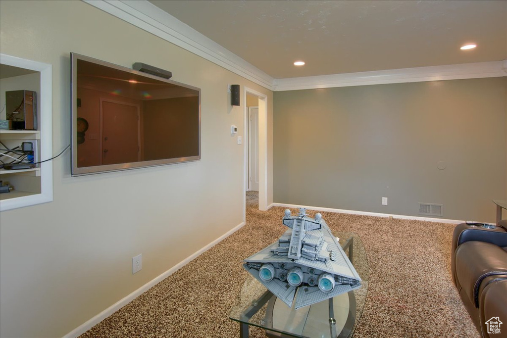 Sitting room featuring carpet, ornamental molding, baseboards, and recessed lighting