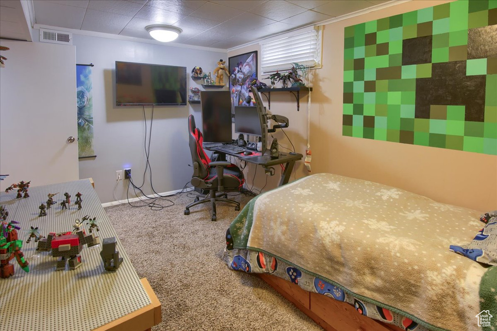 Bedroom featuring carpet and baseboards