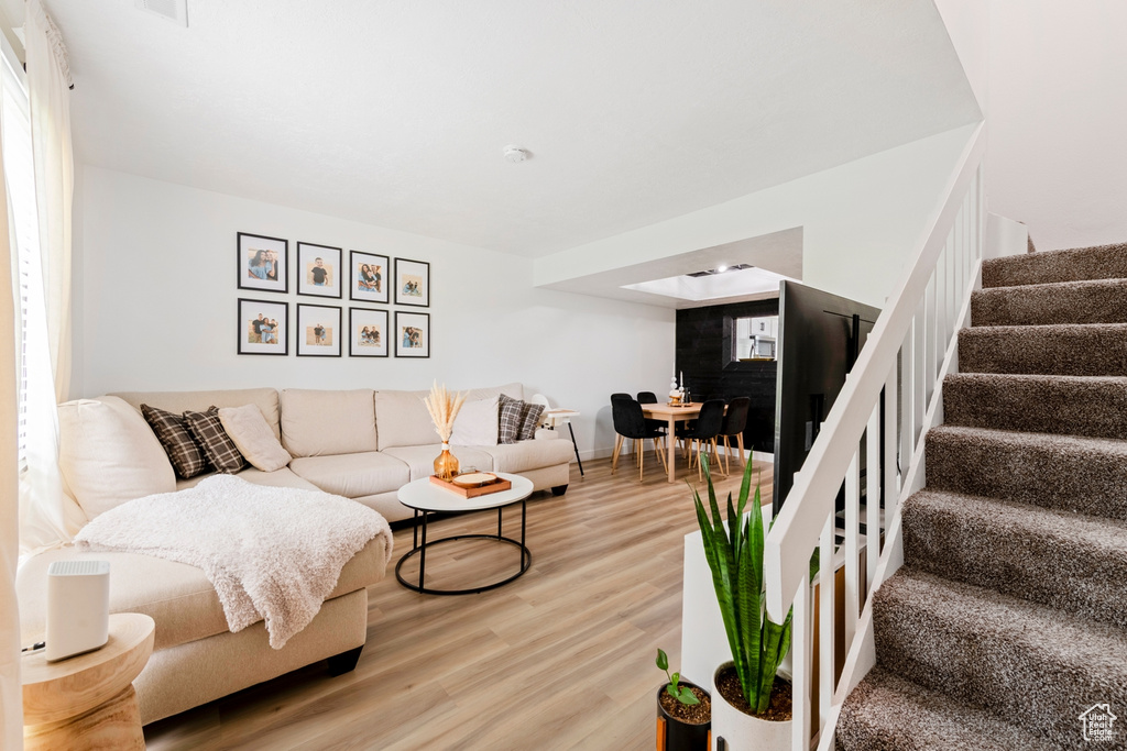 Living area with stairway and wood finished floors
