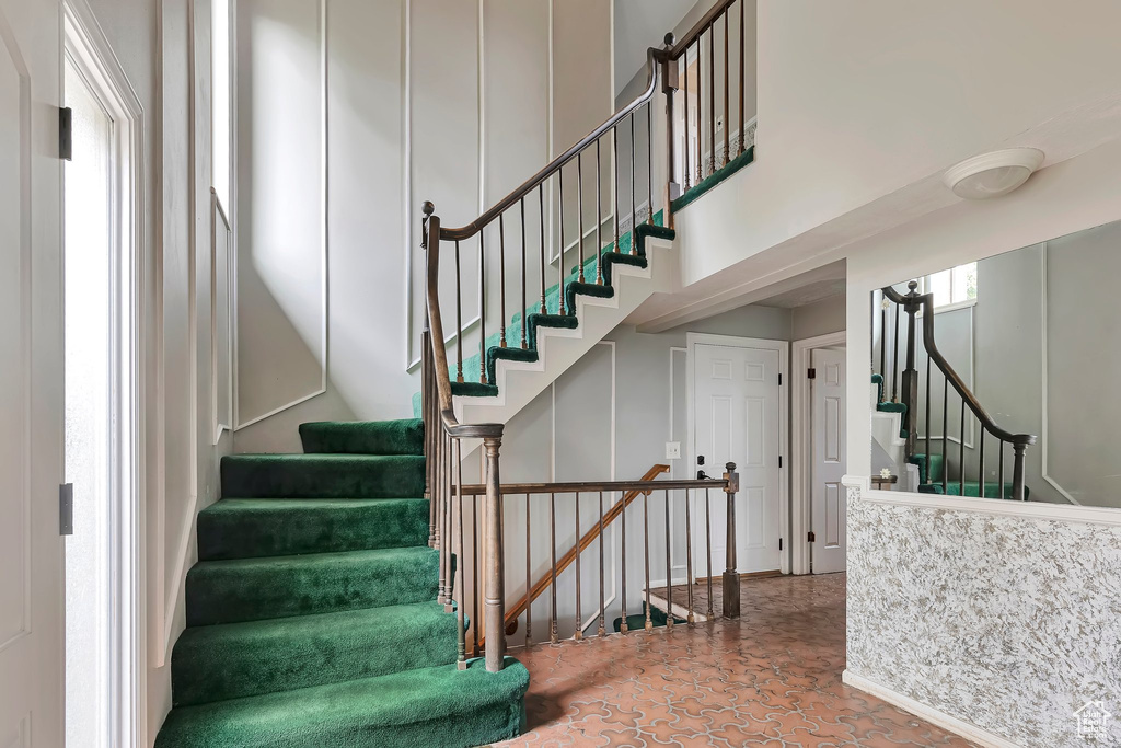 Stairs featuring a high ceiling