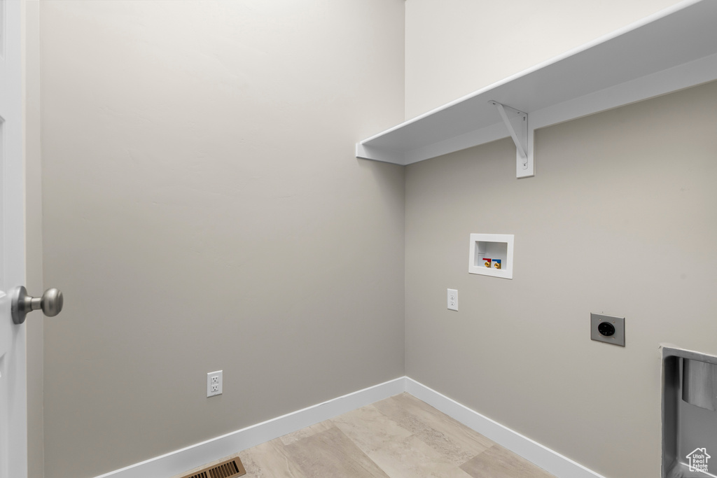 Laundry area featuring hookup for a washing machine, hookup for an electric dryer, and baseboards