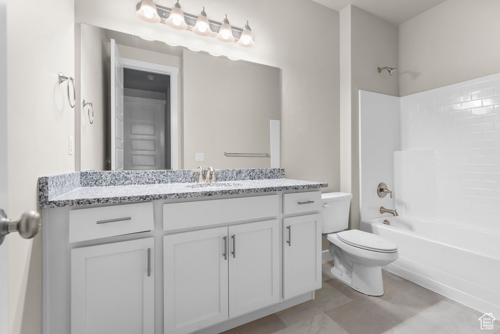 Bathroom with toilet, washtub / shower combination, and vanity