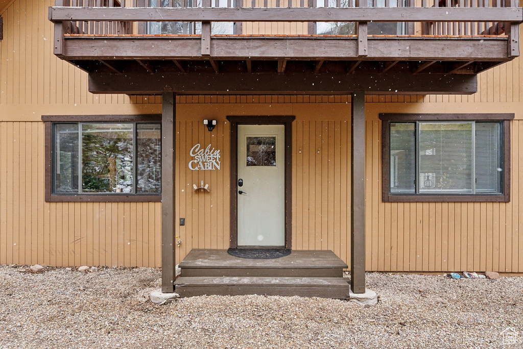 View of exterior entry with a balcony