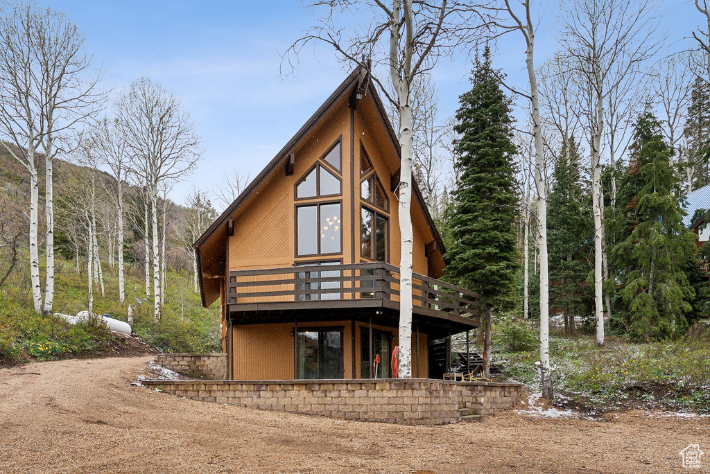 Back of house featuring a wooden deck