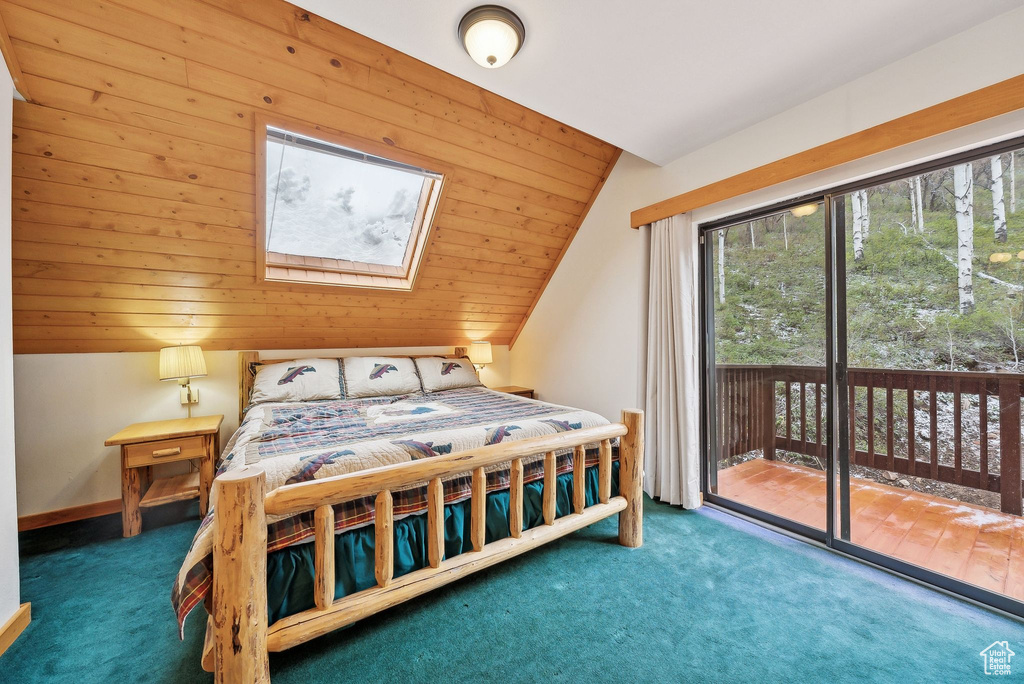Bedroom featuring access to exterior, carpet floors, vaulted ceiling, a skylight, and wood ceiling