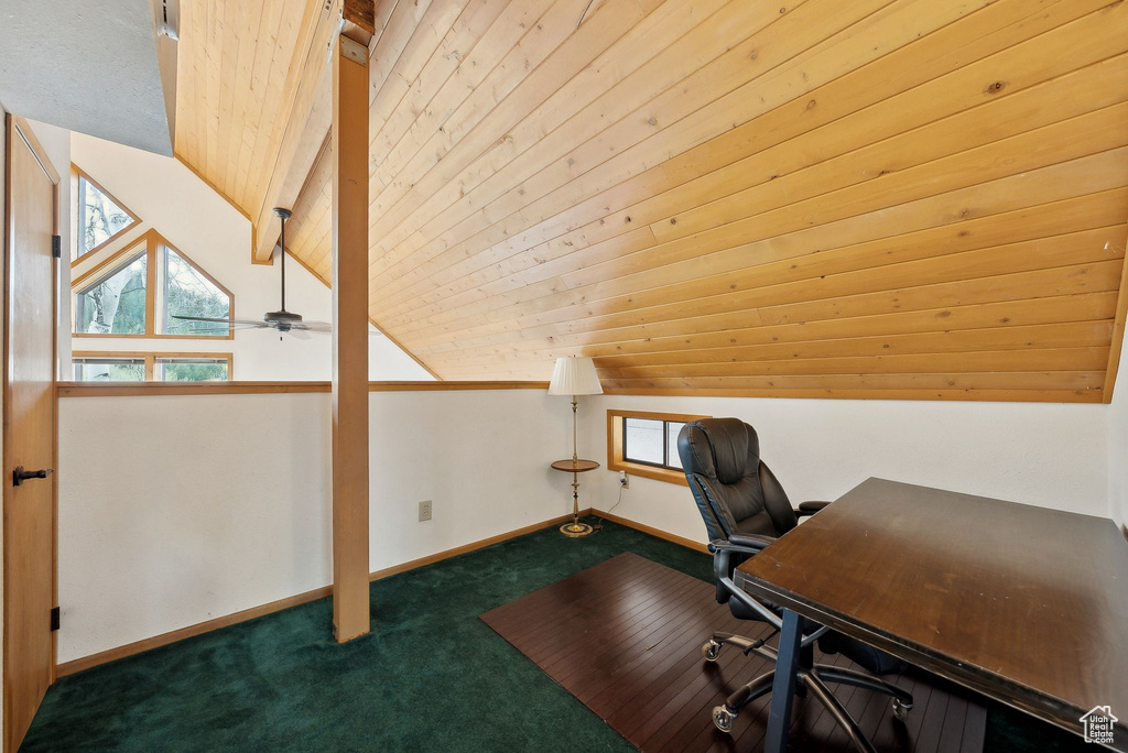 Office space featuring carpet floors, plenty of natural light, vaulted ceiling, and baseboards