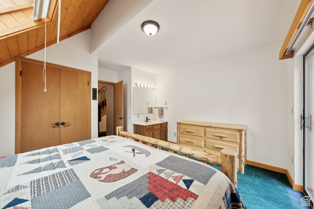 Bedroom featuring carpet, wooden ceiling, a closet, vaulted ceiling, and baseboards