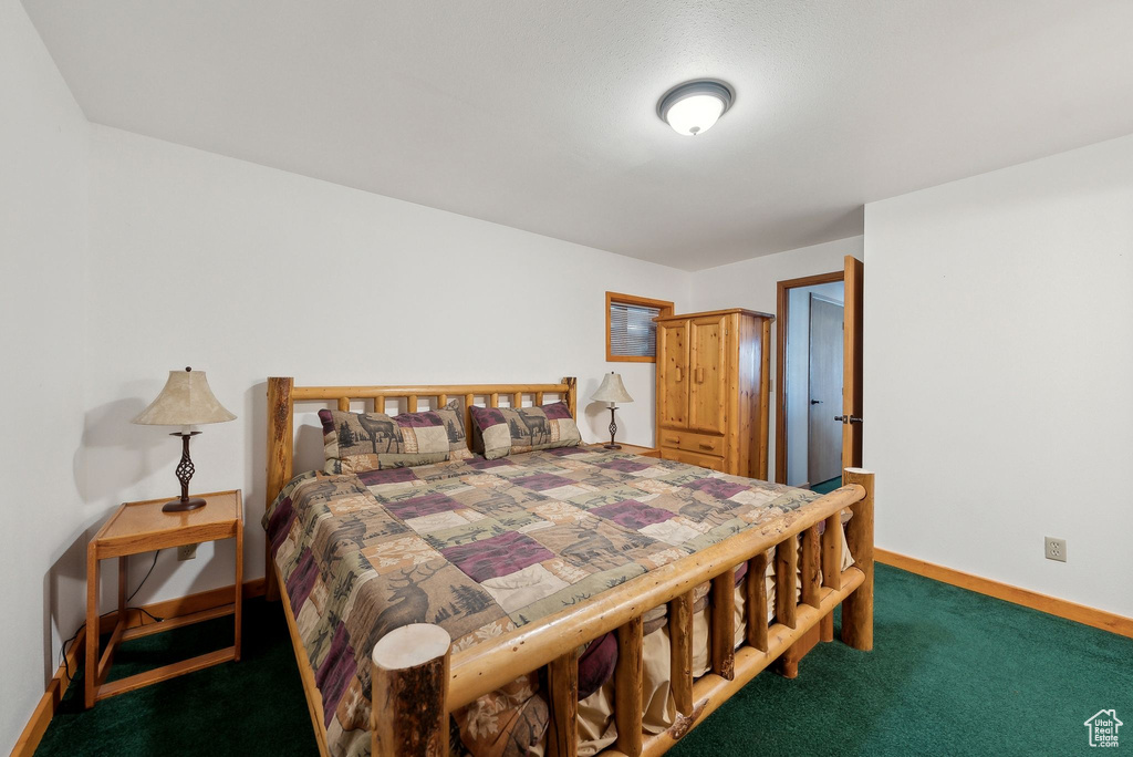 Carpeted bedroom with baseboards