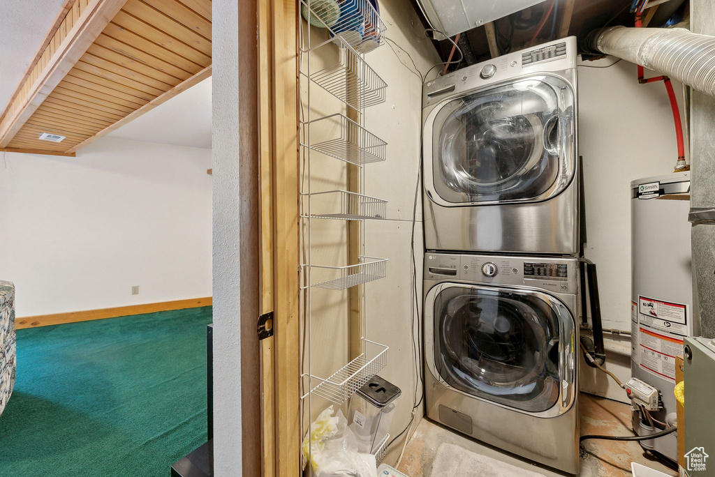 Laundry room with estacked washer and dryer and gas water heater