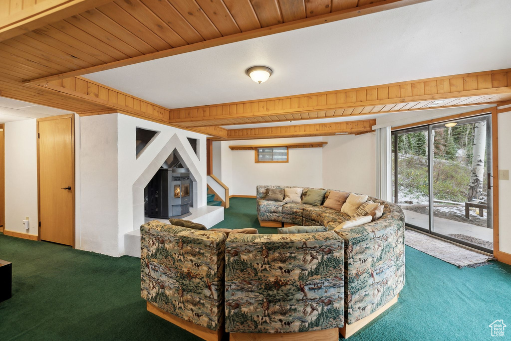 Living room featuring carpet floors, plenty of natural light, wooden ceiling, and stairway