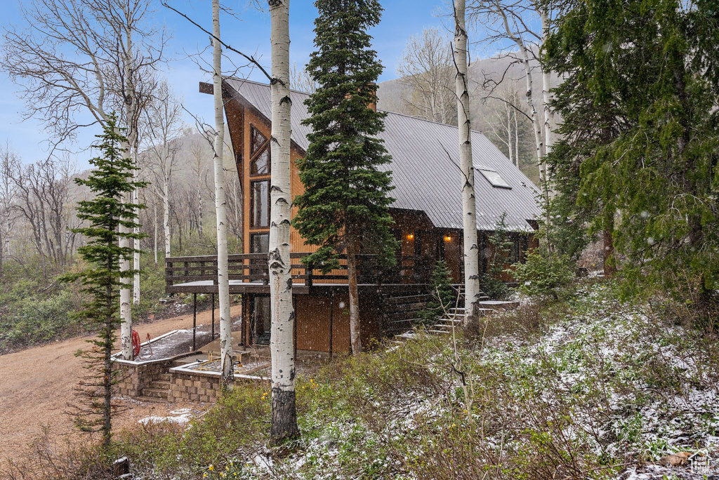 View of side of home featuring metal roof