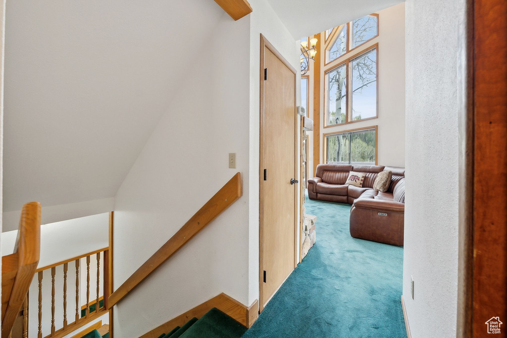 Hall featuring carpet flooring and an upstairs landing