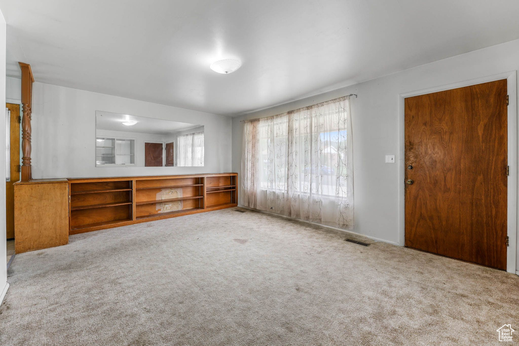Unfurnished living room with carpet floors